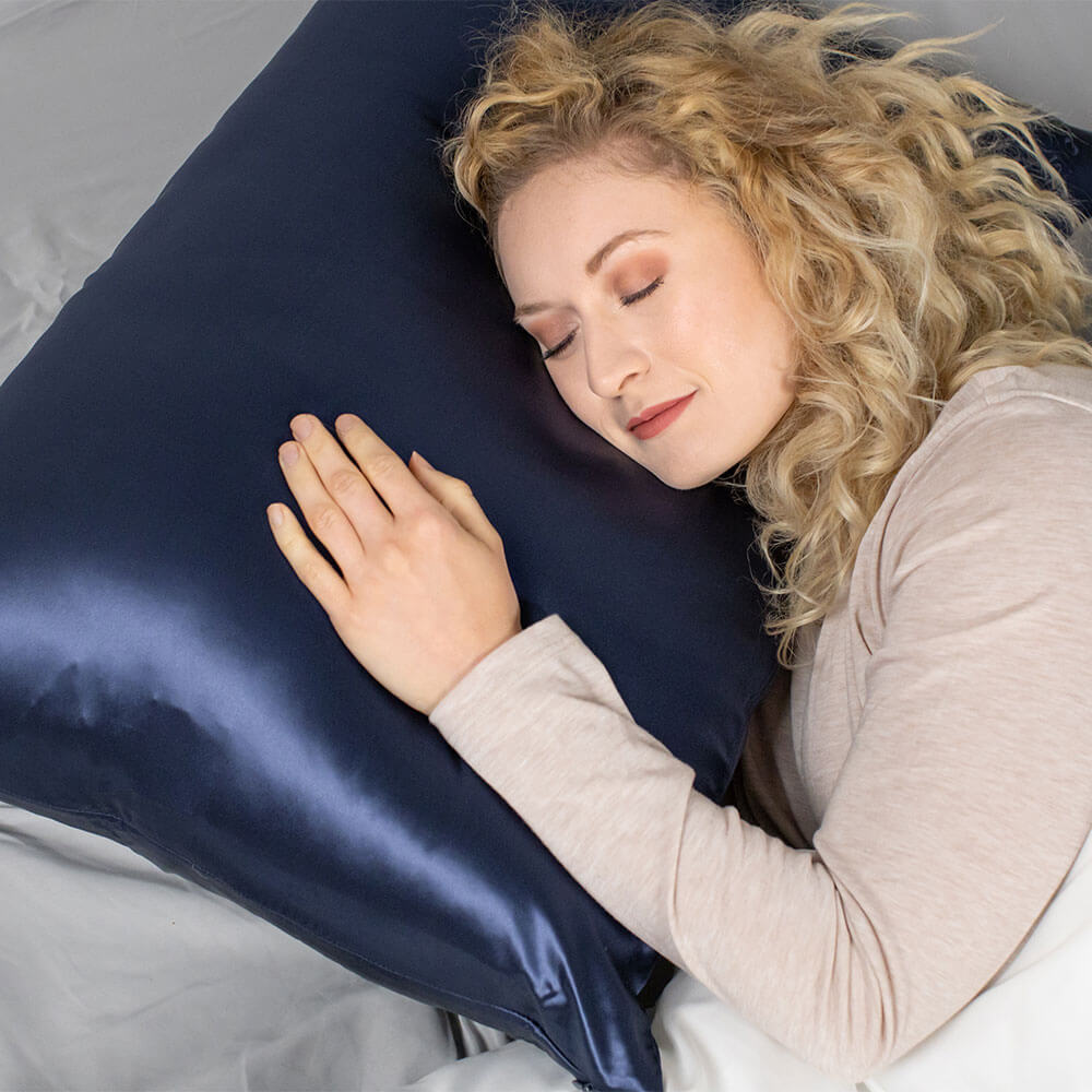 Woman sleeping peacefully on a pillow with blue Blissy mulberry silk pillowcase