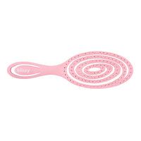 Pink hairbrush with circular design on a white background