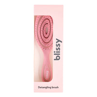 Pink detangling brush with packaging on a white background